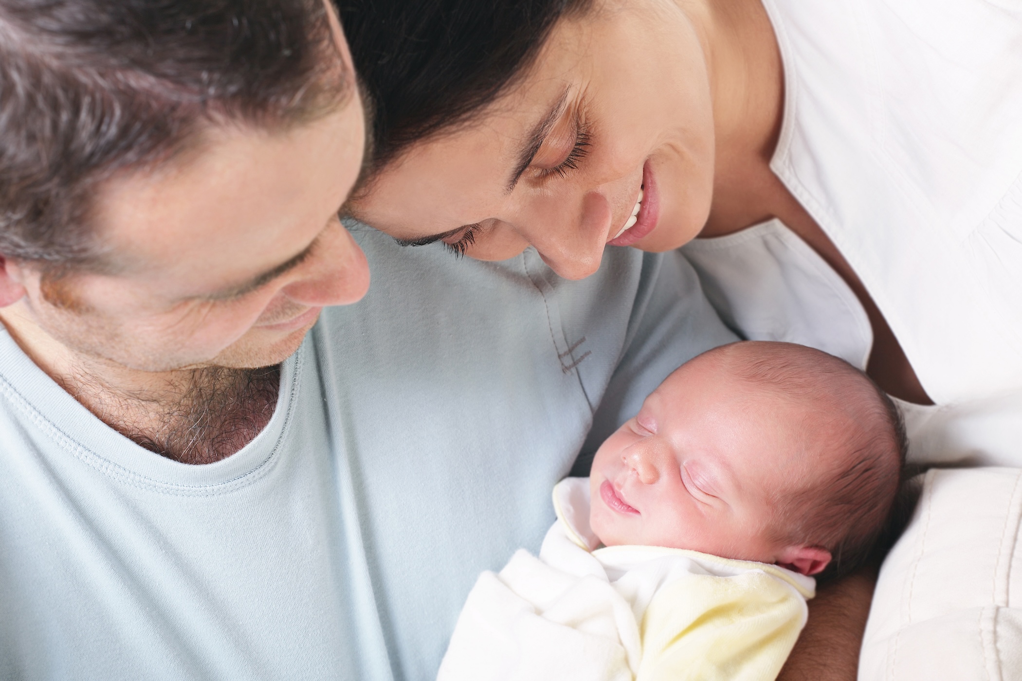 Parents holding their newborn healthy baby