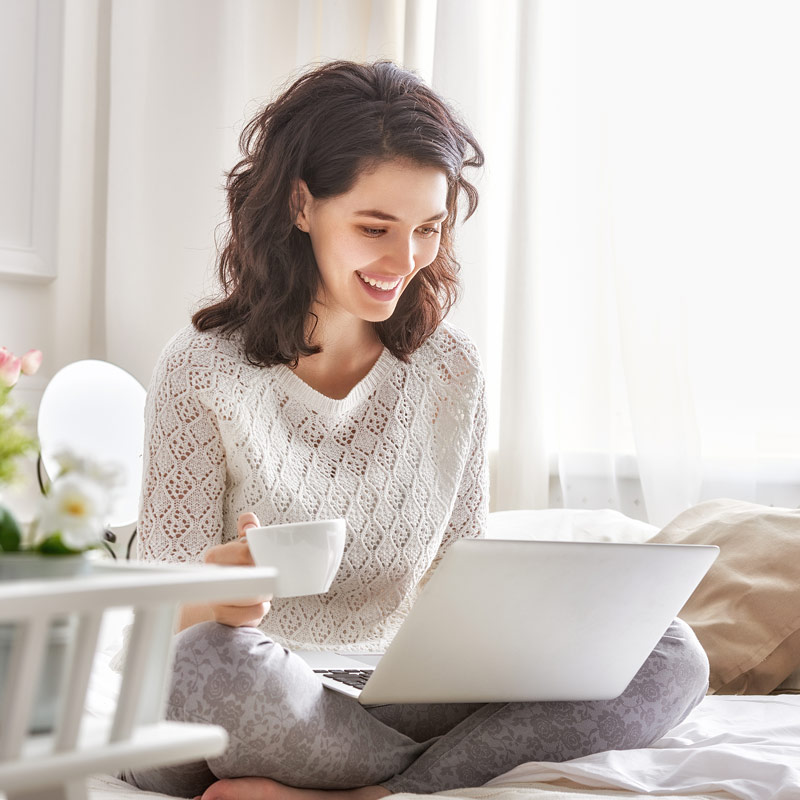 Woman on laptop researching how to get pregnant and fertility